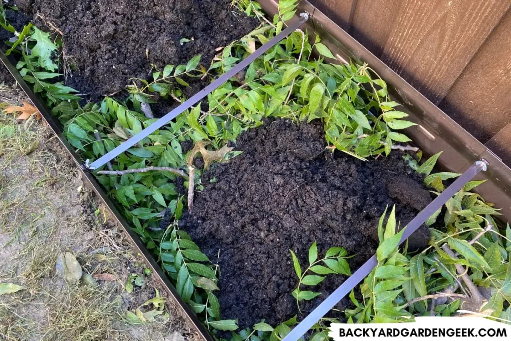Hugelkultur Method With Compost in Raised Garden Bed