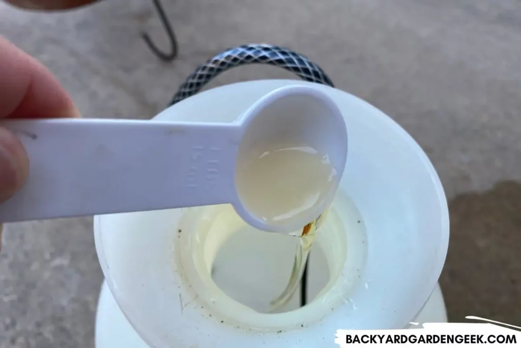 pouring liquid soap into a sprayer