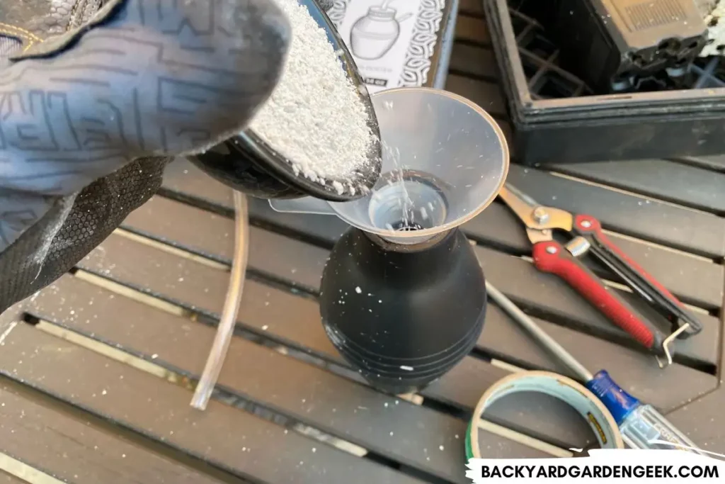Pouring Diatomaceous Earth Into Bulb Duster