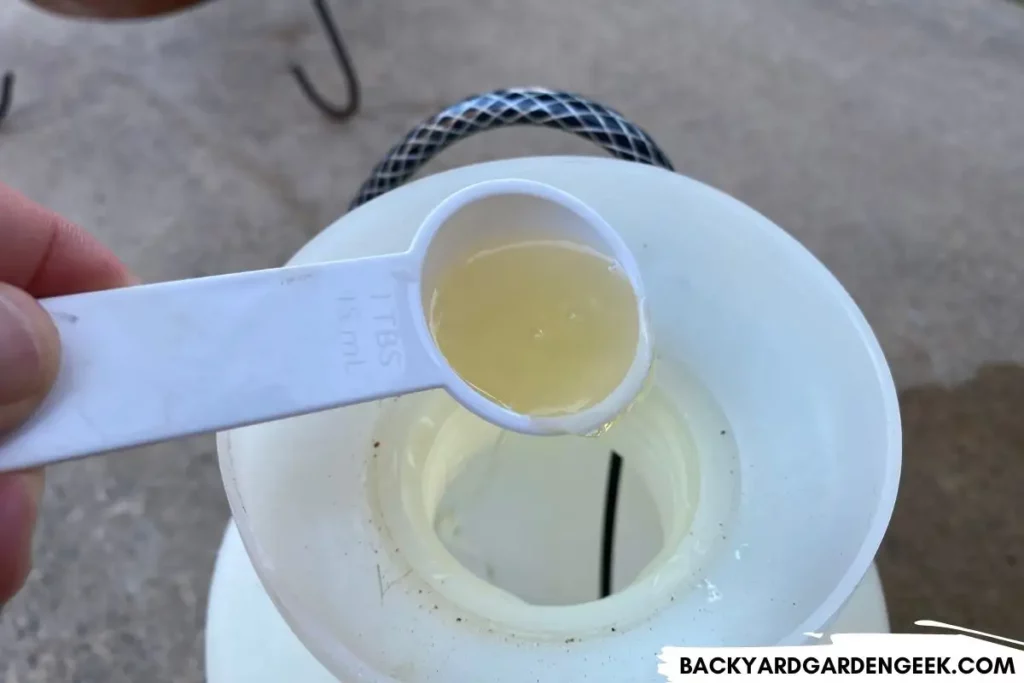 Pouring Liquid Soap Into Garden Sprayer