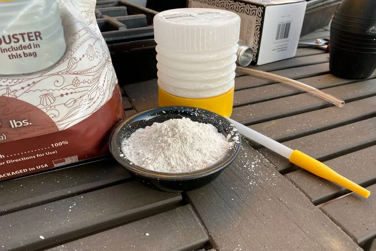 Bowl of Diatomaceous Earth and Bulb Duster