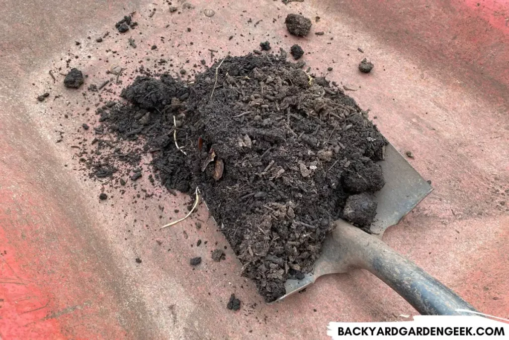 Shoveling Compost Into Wheelbarrow